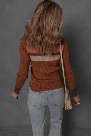 women modeling a stripe detail button front henley. The colors on the henley are a burnt orange with cream, brown, and pink contrasting stripes