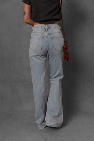 women modeling light wash denim jeans with distressed knees