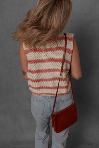 women modeling a cream and blush stripe sleeveless sweater style top